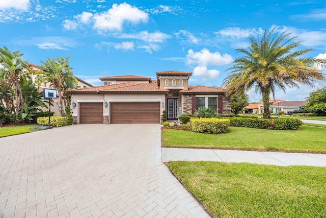 mediterranean / spanish home with a front lawn and a garage