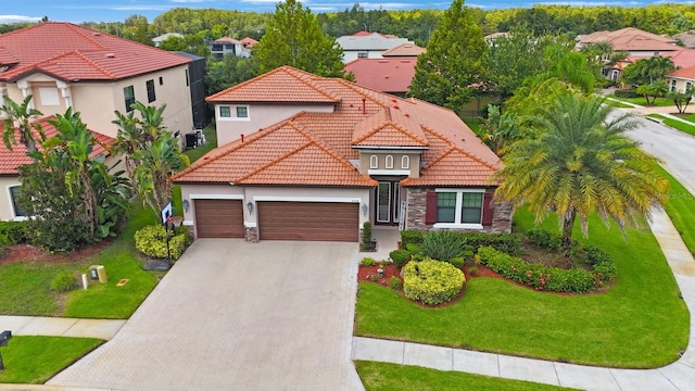 mediterranean / spanish house with a front yard and a garage