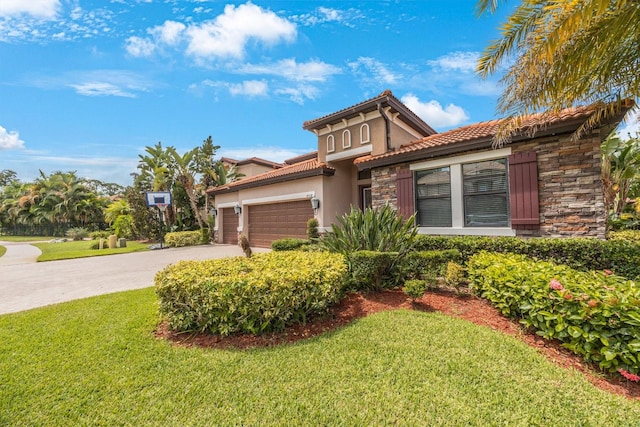 mediterranean / spanish-style home featuring a front lawn and a garage