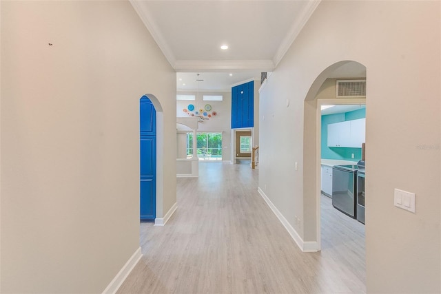 corridor featuring baseboards, arched walkways, visible vents, and ornamental molding