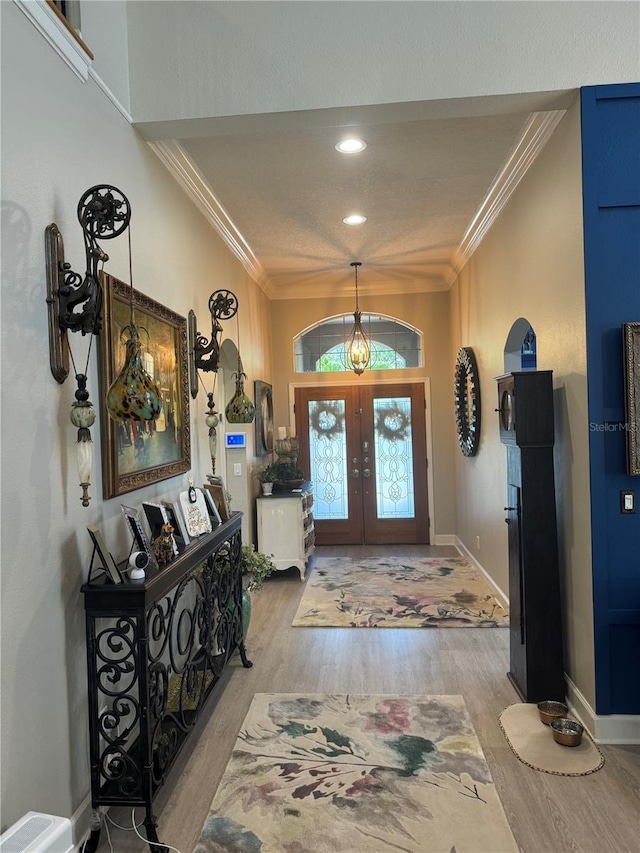 foyer entrance with wood finished floors, baseboards, recessed lighting, french doors, and crown molding