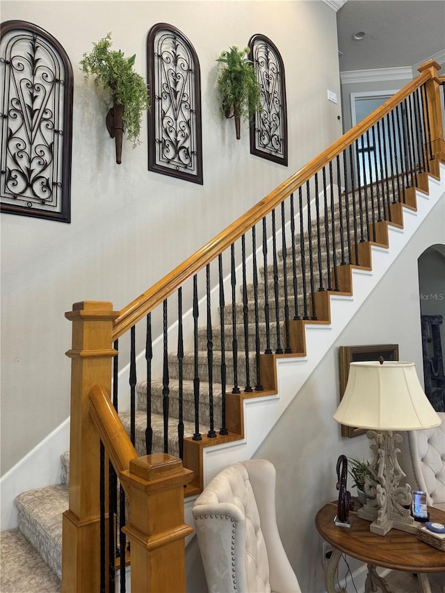 stairs with baseboards and arched walkways