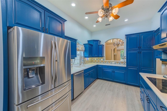 kitchen featuring ceiling fan, blue cabinetry, appliances with stainless steel finishes, and a sink