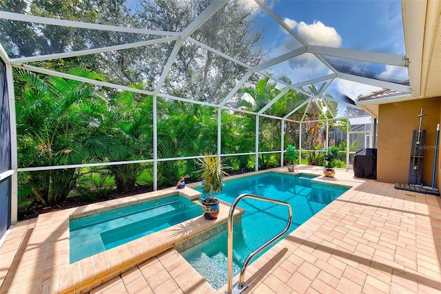 view of pool with a patio, a pool with connected hot tub, and a lanai