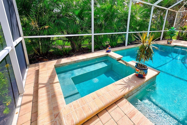 view of pool with glass enclosure and a pool with connected hot tub