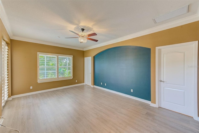 unfurnished room featuring ornamental molding, baseboards, a ceiling fan, and wood finished floors