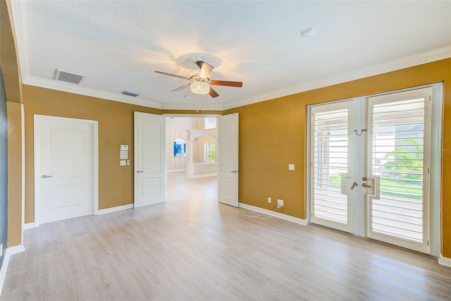 empty room with a ceiling fan, visible vents, baseboards, light wood-style flooring, and french doors