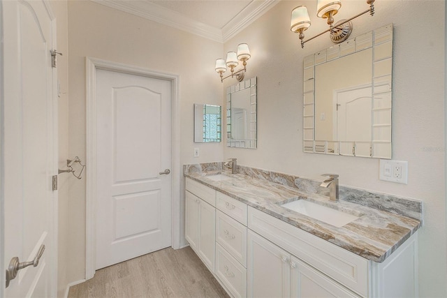 full bath featuring double vanity, ornamental molding, wood finished floors, and a sink