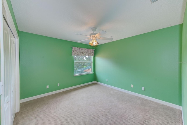 unfurnished bedroom with a closet, baseboards, carpet, and a ceiling fan