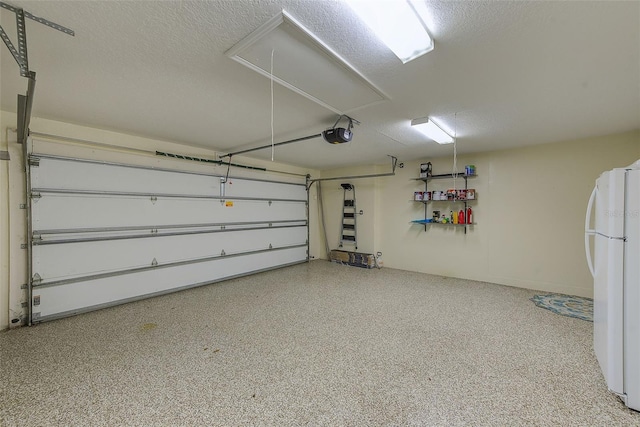 garage with a garage door opener and freestanding refrigerator