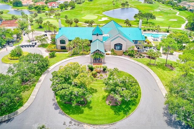 birds eye view of property with a water view and view of golf course