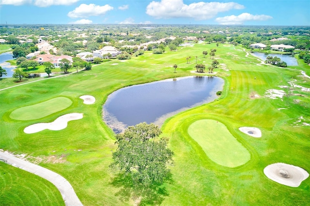 birds eye view of property with a water view and view of golf course