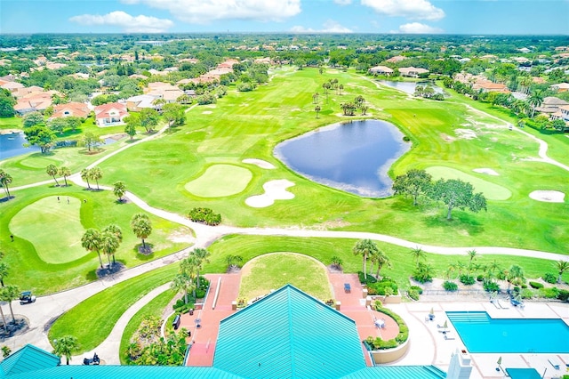 drone / aerial view featuring golf course view and a water view