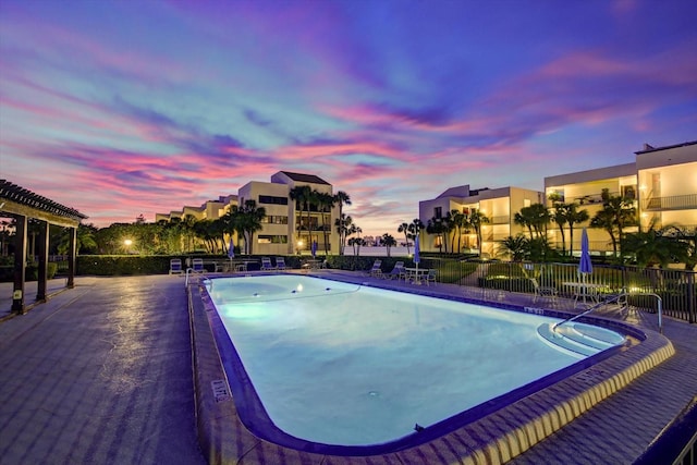 view of pool at dusk