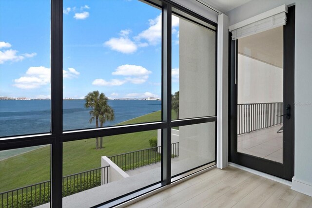 unfurnished sunroom with a water view