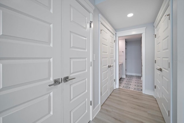 corridor with light hardwood / wood-style floors