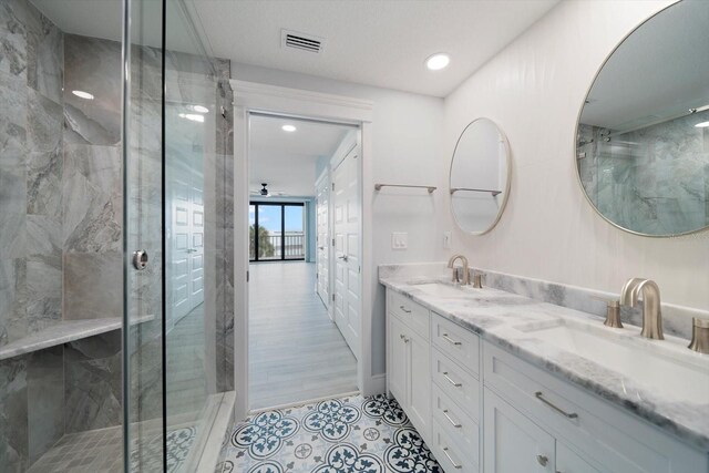 bathroom with vanity, tile patterned flooring, and a shower with door