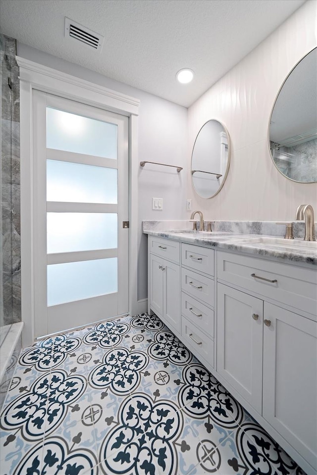 bathroom with vanity and a textured ceiling