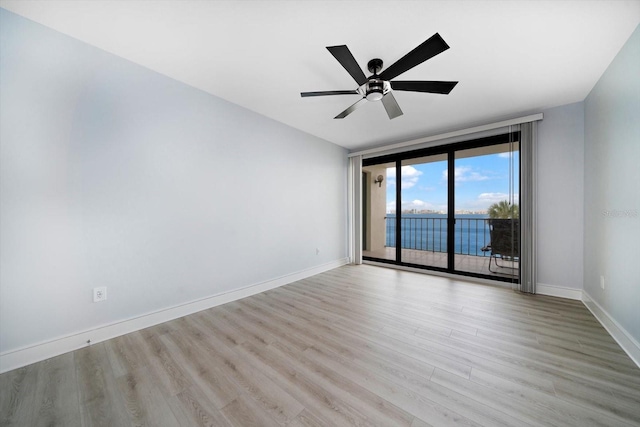 empty room featuring light hardwood / wood-style flooring and ceiling fan