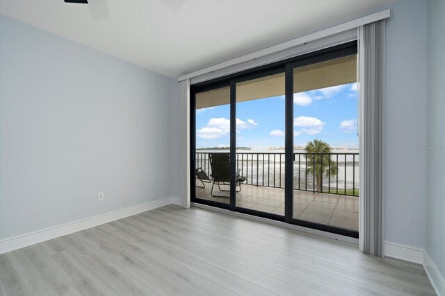 unfurnished room with light wood-type flooring