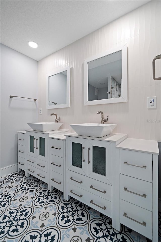 bathroom with a textured ceiling and vanity