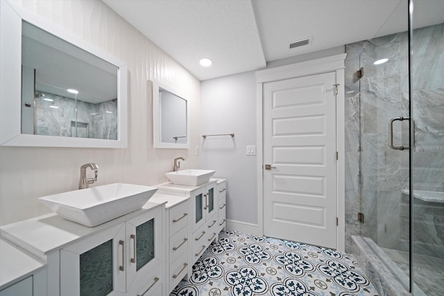 bathroom with tile patterned floors, walk in shower, and vanity