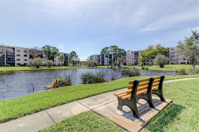 surrounding community featuring a water view and a yard