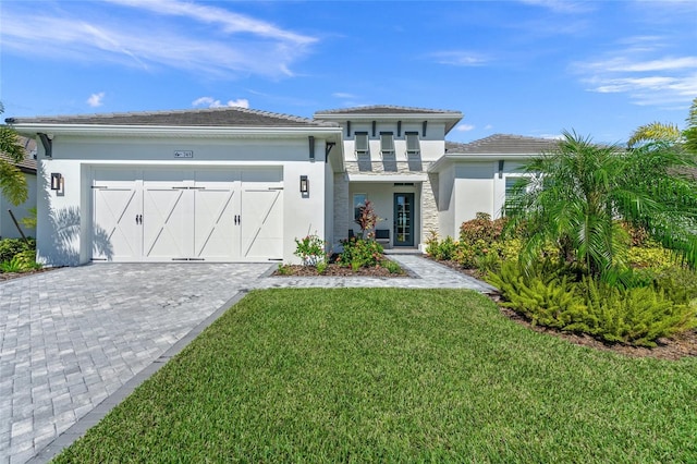 view of front of house featuring a front yard and a garage