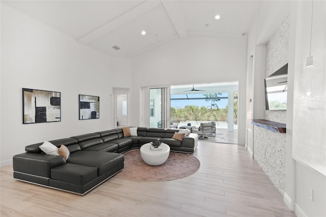 living room featuring high vaulted ceiling, beam ceiling, and light hardwood / wood-style floors