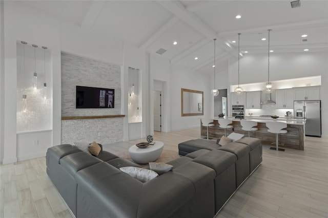 living room featuring high vaulted ceiling, light hardwood / wood-style floors, and beam ceiling