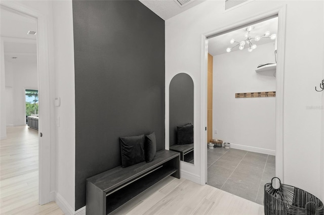 mudroom with light hardwood / wood-style floors