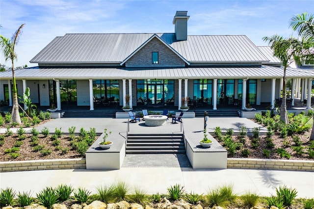 back of house with a patio area and an outdoor fire pit