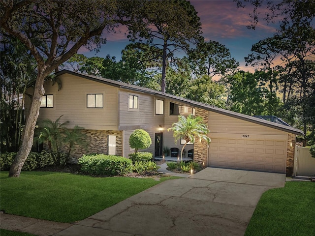 view of front of home featuring a garage and a lawn