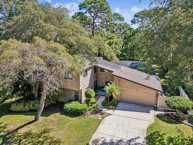 view of front of home featuring a garage and a front yard