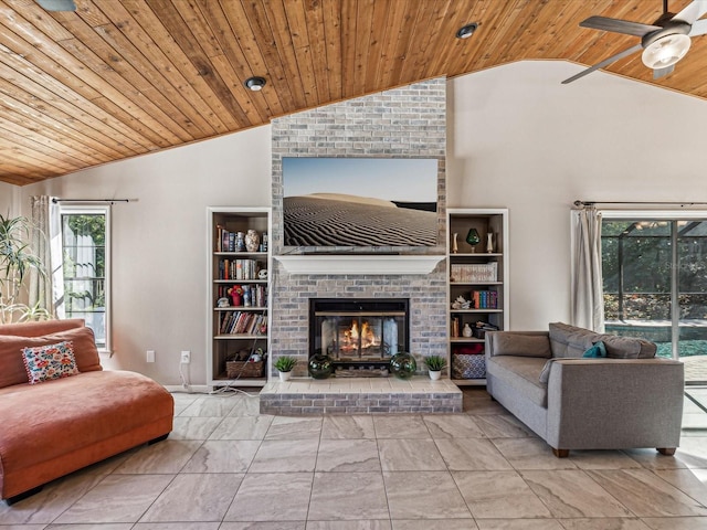 living room with a fireplace, ceiling fan, wood ceiling, and vaulted ceiling