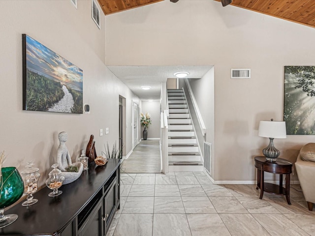 hallway with high vaulted ceiling and wooden ceiling