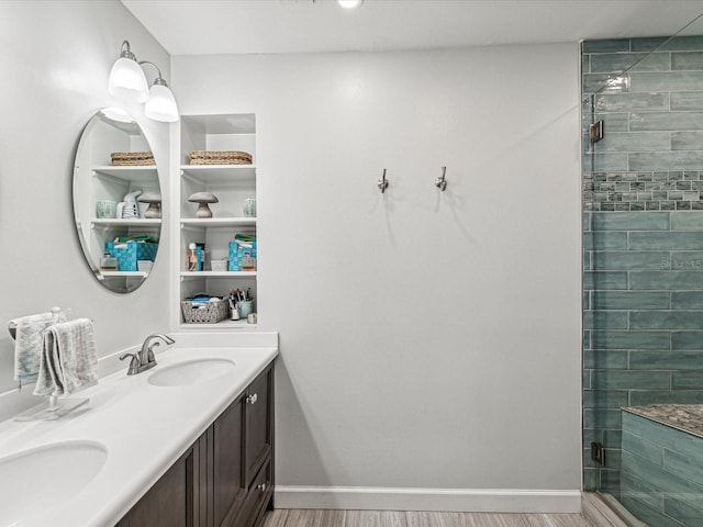 bathroom featuring an enclosed shower and vanity