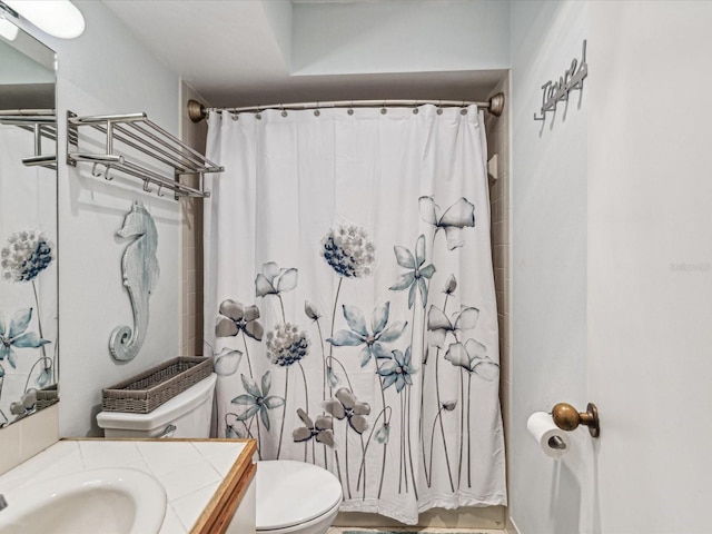 bathroom with toilet, vanity, and a shower with curtain