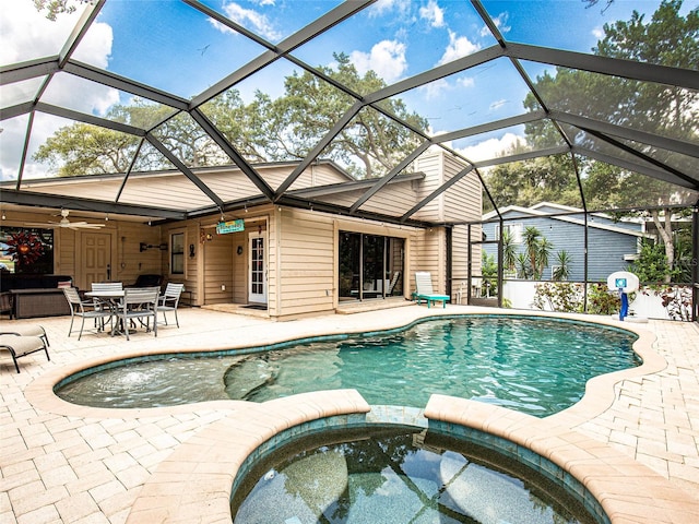 view of pool featuring an in ground hot tub, a lanai, and a patio