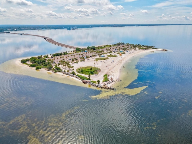 birds eye view of property with a water view and a beach view