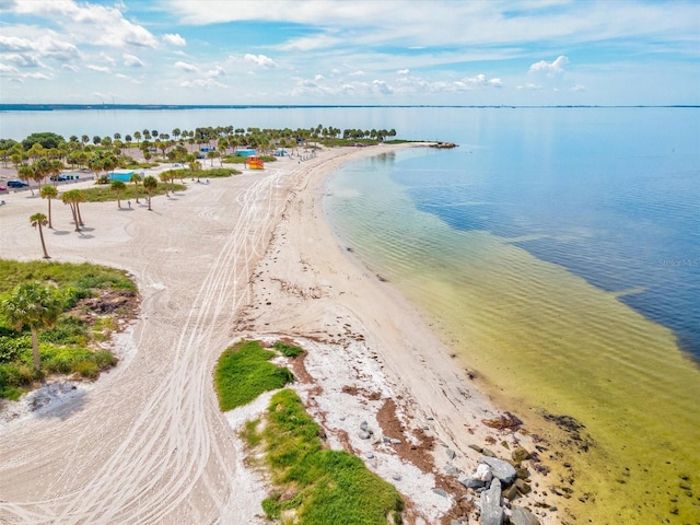 drone / aerial view featuring a water view and a view of the beach