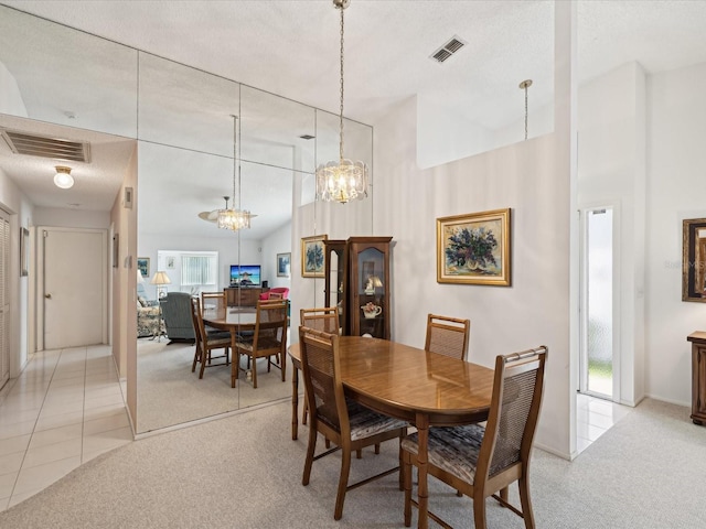 dining space with light carpet, plenty of natural light, and a notable chandelier