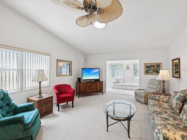 living room featuring ceiling fan, carpet, a textured ceiling, and vaulted ceiling