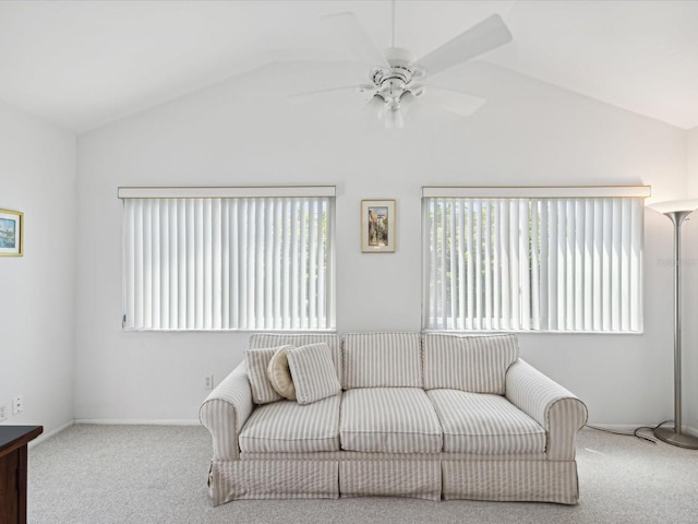 living room featuring ceiling fan, carpet, and vaulted ceiling