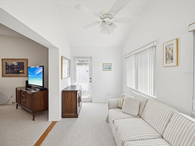 carpeted living room with lofted ceiling and ceiling fan