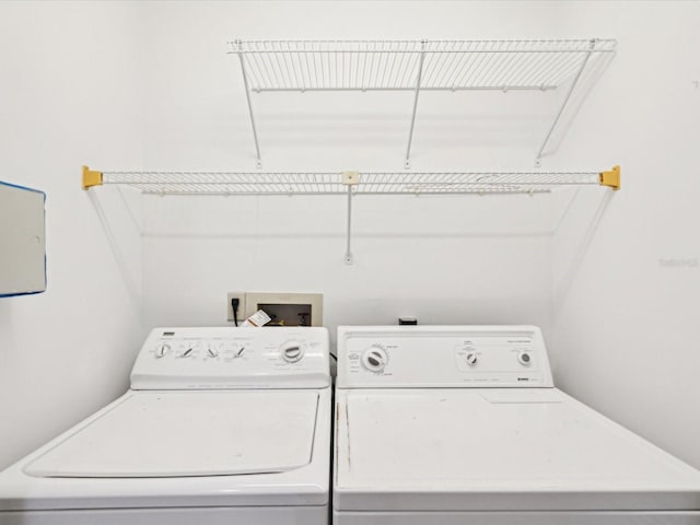 clothes washing area featuring independent washer and dryer