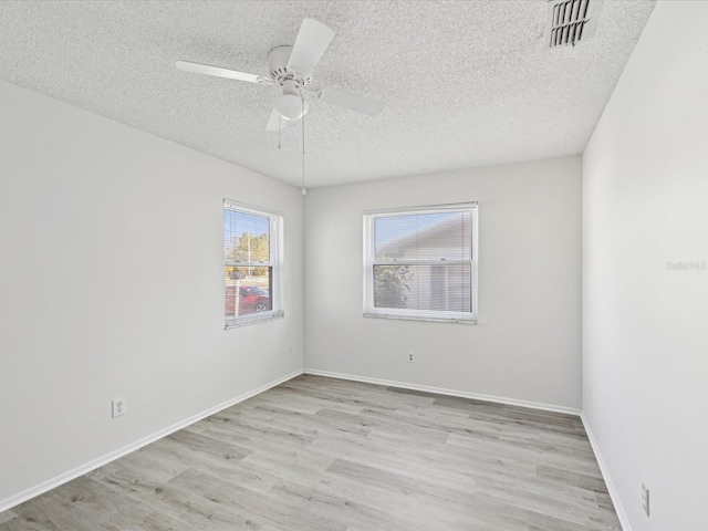 unfurnished room featuring ceiling fan, light hardwood / wood-style flooring, and a textured ceiling