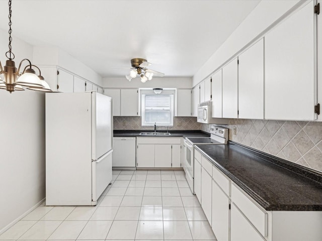 kitchen with sink, white appliances, backsplash, white cabinets, and ceiling fan with notable chandelier