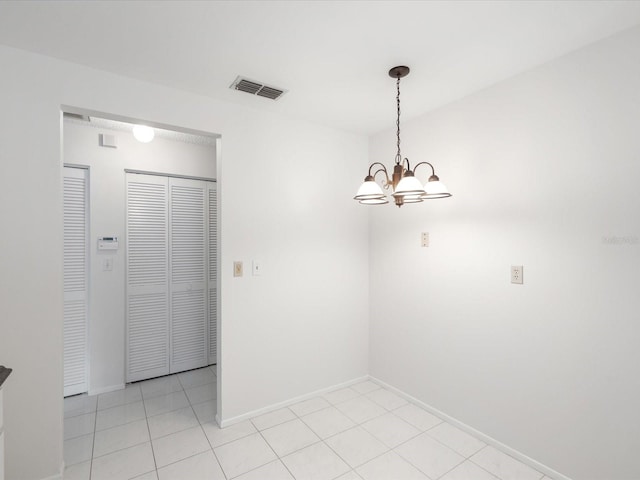 unfurnished dining area with light tile patterned flooring and a notable chandelier