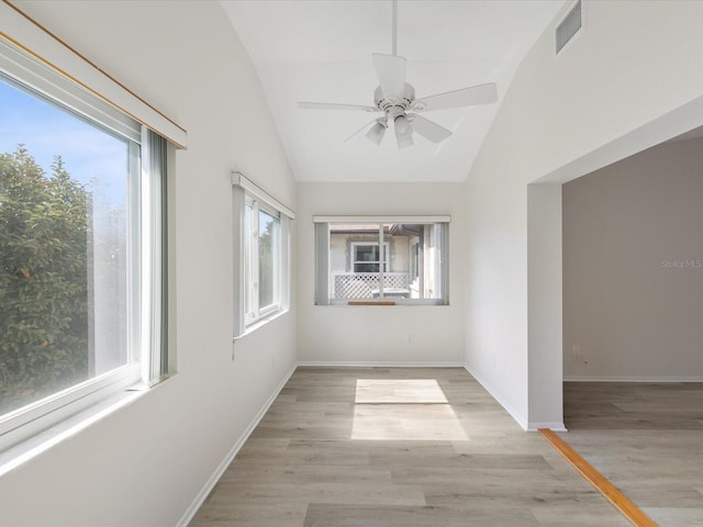 unfurnished sunroom with plenty of natural light, ceiling fan, and vaulted ceiling